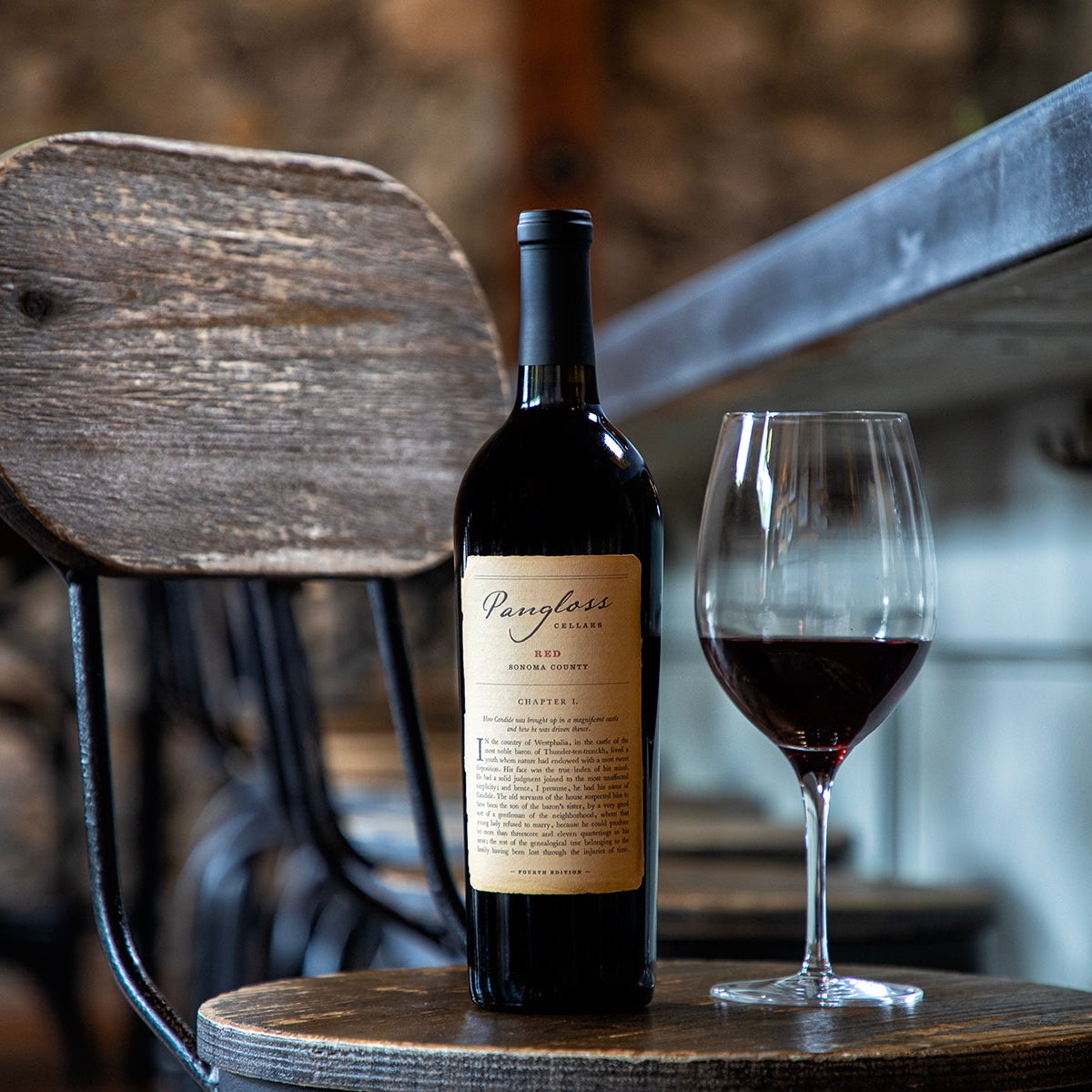 Wine bottle and glass on a wooden stool with rustic background